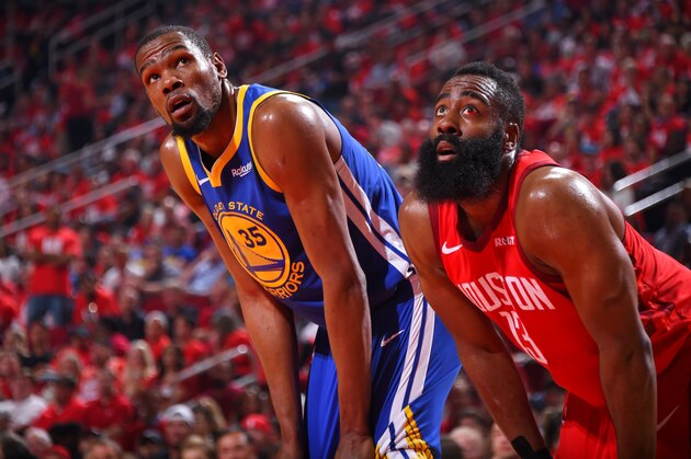 HOUSTON, TX - MAY 6:  Kevin Durant #35 of the Golden State Warriors and James Harden #13 of the Houston Rockets look on during Game Four of the Western Conference Semifinals of the 2019 NBA Playoffs on May 6, 2019 at the Toyota Center in Houston, Texas. NOTE TO USER: User expressly acknowledges and agrees that, by downloading and/or using this photograph, user is consenting to the terms and conditions of the Getty Images License Agreement. Mandatory Copyright Notice: Copyright 2019 NBAE (Photo by Bill Baptist/NBAE via Getty Images)