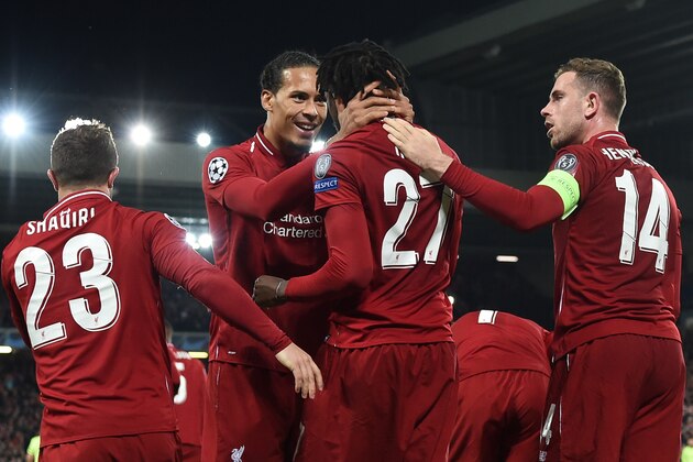 Liverpool's Belgium striker Divock Origi (2R) celebrates with Liverpool's Dutch defender Virgil van Dijk after scoring their fourth and winning goal during the UEFA Champions league semi-final second leg football match between Liverpool and Barcelona at Anfield in Liverpool, north west England on May 7, 2019. (Photo by Paul ELLIS / AFP)        (Photo credit should read PAUL ELLIS/AFP/Getty Images)