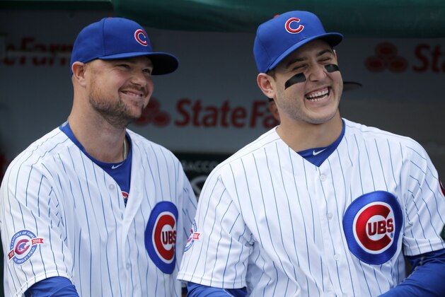 Chicago Cubs' Jon Lester, left, and Anthony Rizzo laugh during a video tribute to catcher David Ross before a baseball game between the Cubs and the St. Louis Cardinals Friday, Sept. 23, 2016, in Chicago. (AP Photo/Charles Rex Arbogast)