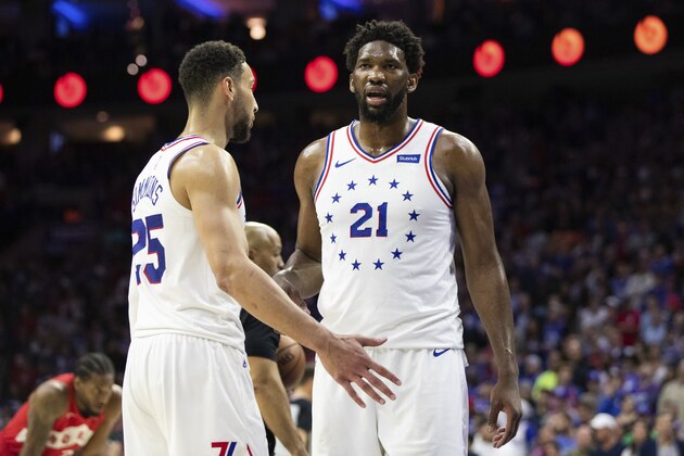 Philadelphia 76ers' Joel Embiid, right, looks on with Ben Simmons, left, during the second half of Game 4 of a second-round NBA basketball playoff series against the Toronto Raptors, Sunday, May 5, 2019, in Philadelphia. Raptors won 101-96. (AP Photo/Chris Szagola)