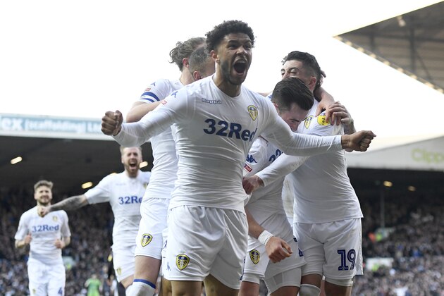 LEEDS, ENGLAND - APRIL 13: Jack Harrison of Leeds United is mobbed by with teammates Luke Ayling, Tyler Roberts, Pablo Hernandez after scoring the opening goal during the Sky Bet Championship match between Leeds United and Sheffield Wednesday at Elland Road on April 13, 2019 in Leeds, England. (Photo by George Wood/Getty Images)