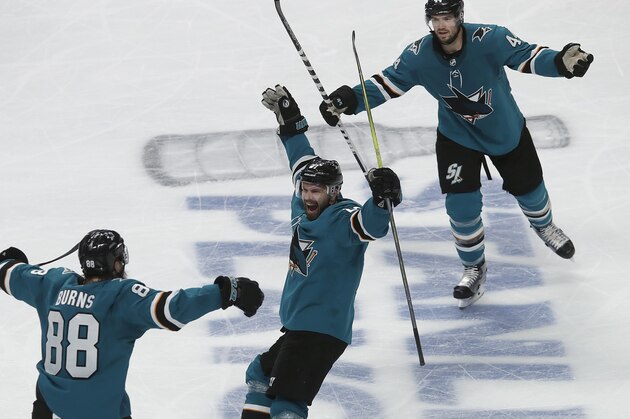 San Jose Sharks right wing Joonas Donskoi, center, celebrates with defenseman Brent Burns (88) and defenseman Marc-Edouard Vlasic (44) after scoring a goal against the Colorado Avalanche during the second period of Game 7 of an NHL hockey second-round playoff series in San Jose, Calif., Wednesday, May 8, 2019. (AP Photo/Jeff Chiu)
