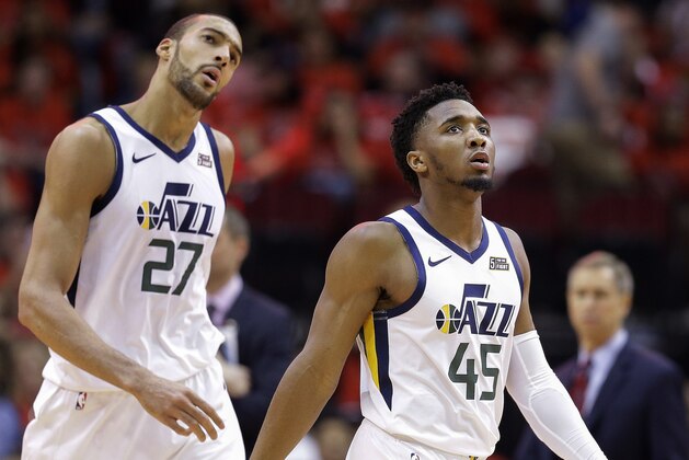 Utah Jazz guard Donovan Mitchell (45) and center Rudy Gobert look at the scoreboard during a timeout during the second half of Game 1 of an NBA basketball first-round playoff series against the Houston Rockets, Sunday, April 14, 2019, in Houston. Houston won the game 122-90. (AP Photo/Eric Christian Smith)