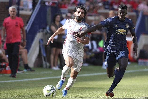 Liverpool midfielder Mohamed Salah (11) controls the ball in front of Manchester United Axel Tuanzebe during the first half of an International Champions Cup tournament soccer match, Saturday, July 28, 2018, in Ann Arbor, Mich. (AP Photo/Carlos Osorio)