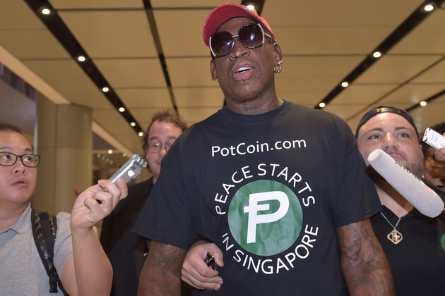 Retired American professional basketball player Dennis Rodman speaks to the press as he arrives at Changi International airport ahead of US-North Korea summit in Singapore on June 11, 2018. - North Korea's  Kim Jong Un and US President Donald Trump meet on June 12 for an unprecedented summit in an attempt to address the last festering legacy of the Cold War, with the US President calling it a