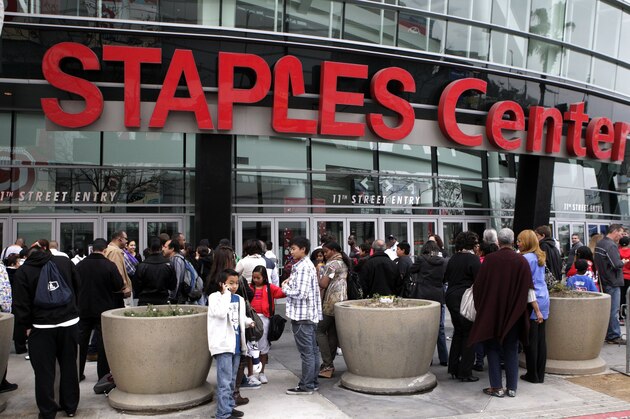 FILE - In this March 19, 2011 file photo, basketball fans wait outside Staples Center before an NBA basketball game  between the Los Angeles Clippers and the Cleveland Cavaliers in Los Angeles. With three permanent sports teams and a jam-packed slate of concerts and shows, Staples Center is always among the world’s busiest arenas, but this weekend will be the craziest on record. After a remarkable run of postseason success, the NBA’s Lakers and Clippers and the NHL’s Kings are combining to host six playoff games in a jaw-dropping four days _ and with a major cycling race finishing right outside the building Sunday, no less. (AP Photo/File)