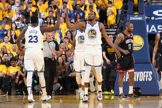 OAKLAND, CA - MAY 8: Draymond Green #23 and Kevin Durant #35 of the Golden State Warriors high five during Game Five of the Western Conference Semifinals of the 2019 NBA Playoffs against the Houston Rockets on May 8, 2019 at ORACLE Arena in Oakland, California. NOTE TO USER: User expressly acknowledges and agrees that, by downloading and/or using this photograph, user is consenting to the terms and conditions of Getty Images License Agreement. Mandatory Copyright Notice: Copyright 2019 NBAE (Photo by Joe Murphy/NBAE via Getty Images)