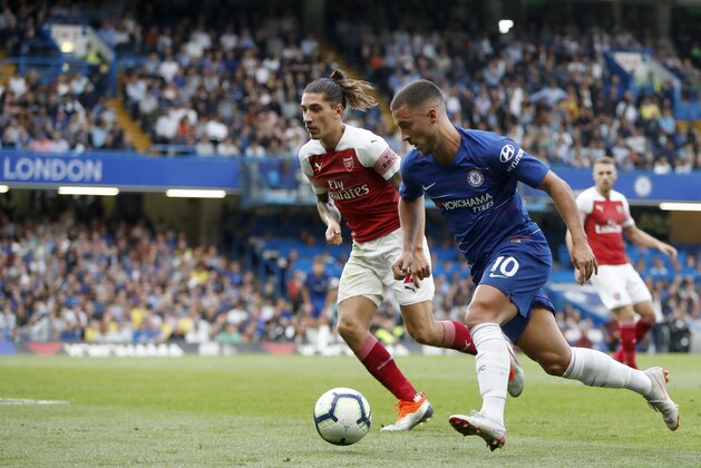Chelsea's Eden Hazard, front, and Arsenal's Hector Bellerin run for the ball during the English Premier League soccer match between Chelsea and Arsenal at Stamford bridge stadium in London, Saturday, Aug. 18, 2018. (AP Photo/Alastair Grant)