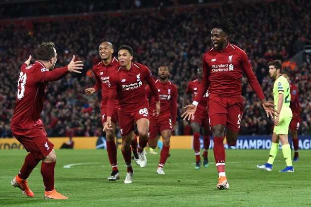 Liverpool's Belgian striker Divock Origi (R) celebrates after scoring their fourth goal during the UEFA Champions league semi-final second leg football match between Liverpool and Barcelona at Anfield in Liverpool, north west England on May 7, 2019. (Photo by Paul ELLIS / AFP)        (Photo credit should read PAUL ELLIS/AFP/Getty Images)