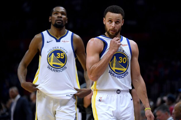 LOS ANGELES, CALIFORNIA - APRIL 26:  Stephen Curry #30 and Kevin Durant #35 of the Golden State Warriors react as they leave the game late in the fourth quarter with a lead in a 129-110 win over the LA Clippers during Game Six of Round One of the 2019 NBA Playoffs at Staples Center on April 26, 2019 in Los Angeles, California. (Photo by Harry How/Getty Images)  NOTE TO USER: User expressly acknowledges and agrees that, by downloading and or using this photograph, User is consenting to the terms and conditions of the Getty Images License Agreement.