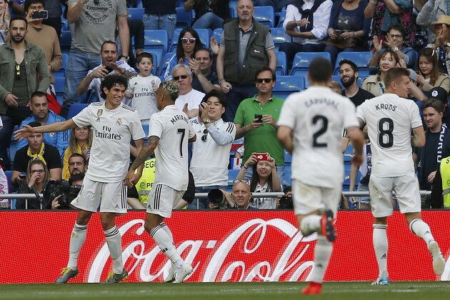 Real Madrid's Jesus Vallejo, left, celebrates after scoring his side's 2nd goal during a Spanish La Liga soccer match between Real Madrid and Villarreal at the Santiago Bernabeu stadium in Madrid, Spain, Sunday, May 5, 2019. (AP Photo/Paul White)