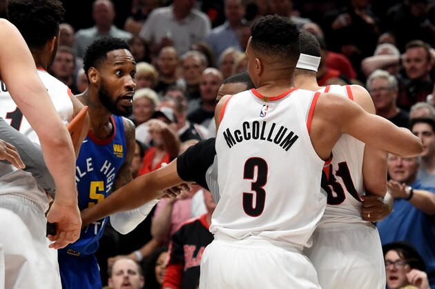 PORTLAND, OREGON - MAY 09: CJ McCollum #3 of the Portland Trail Blazers holds back Seth Curry #31 as he tries to go after Will Barton #5 of the Denver Nuggets during an altercation in the second half of Game Six of the Western Conference Semifinals at Moda Center on May 09, 2019 in Portland, Oregon. The Blazers won 119-108. NOTE TO USER: User expressly acknowledges and agrees that, by downloading and or using this photograph, User is consenting to the terms and conditions of the Getty Images License Agreement. (Photo by Steve Dykes/Getty Images)   (Photo by Steve Dykes/Getty Images)