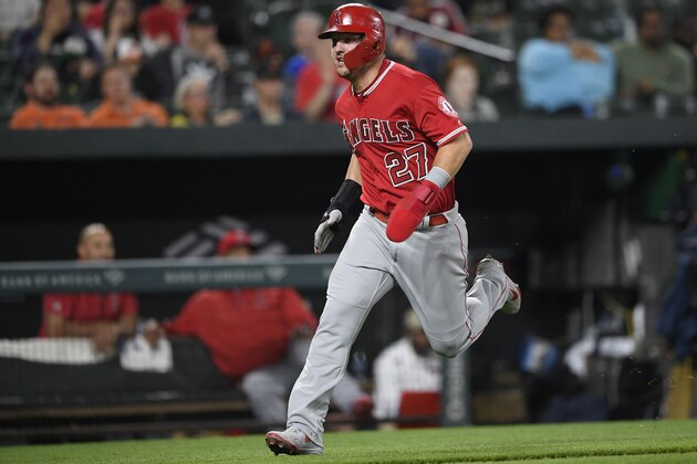 Los Angeles Angels' Mike Trout runs toward home to score on a single by Andrelton Simmons during the fifth inning of a baseball game against the Baltimore Orioles on Friday, May 10, 2019, in Baltimore. (AP Photo/Nick Wass)