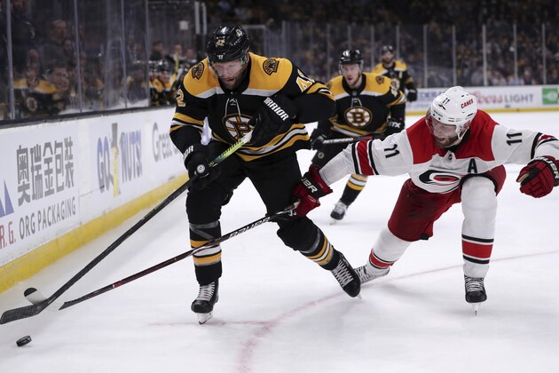 Carolina Hurricanes' Jordan Staal (11) tries to poke the puck away from Boston Bruins' David Backes, left, during the second period in Game 1 of the NHL hockey Stanley Cup Eastern Conference finals, Thursday, May 9, 2019, in Boston. (AP Photo/Charles Krupa)