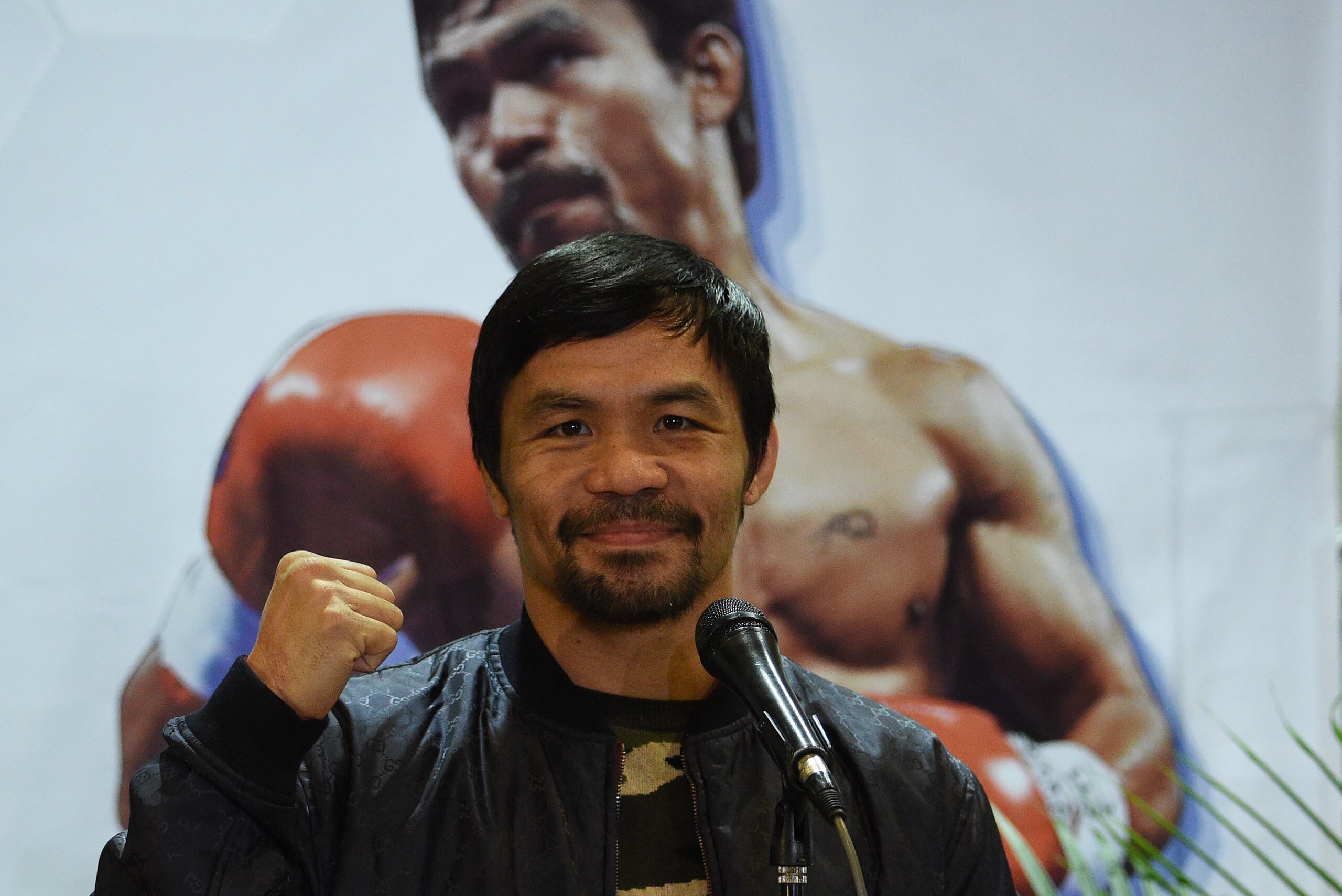 Philippine boxing icon Manny Pacquiao poses for photos during a press conference shortly after arriving at the international airport in Manila on January 24, 2019, days after defeating US boxer Adrien Broner in Las Vegas. (Photo by TED ALJIBE / AFP)        (Photo credit should read TED ALJIBE/AFP/Getty Images)