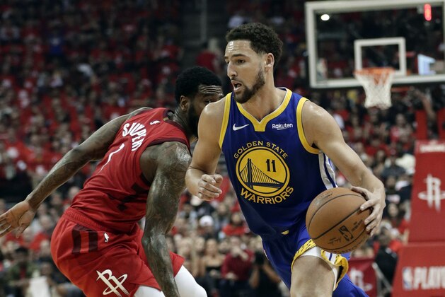 Golden State Warriors' Klay Thompson (11) drives past Houston Rockets' Iman Shumpert during the first half of Game 6 of a second-round NBA basketball playoff series Friday, May 10, 2019, in Houston. (AP Photo/Eric Gay)
