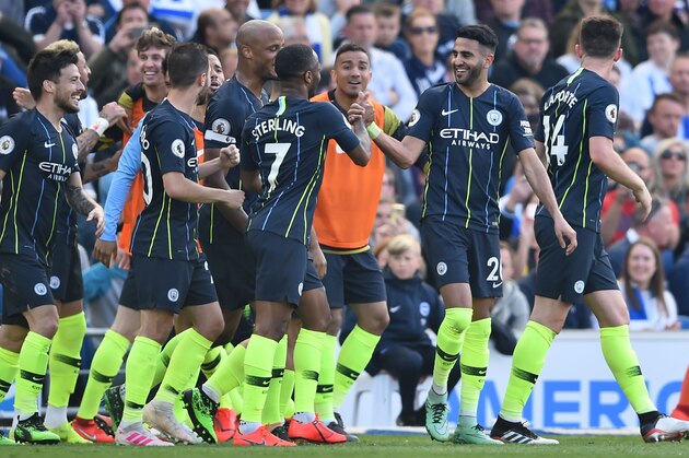 Manchester City's Algerian midfielder Riyad Mahrez (2R) celebrates scoring their third goal during the English Premier League football match between Brighton and Hove Albion and Manchester City at the American Express Community Stadium in Brighton, southern England on May 12, 2019. (Photo by Glyn KIRK / AFP) / RESTRICTED TO EDITORIAL USE. No use with unauthorized audio, video, data, fixture lists, club/league logos or 'live' services. Online in-match use limited to 120 images. An additional 40 images may be used in extra time. No video emulation. Social media in-match use limited to 120 images. An additional 40 images may be used in extra time. No use in betting publications, games or single club/league/player publications. /         (Photo credit should read GLYN KIRK/AFP/Getty Images)
