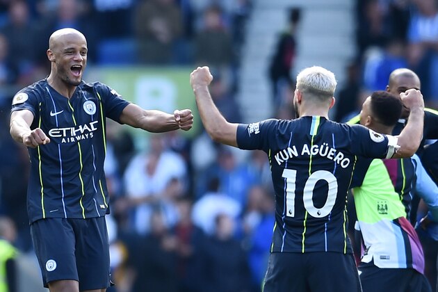 (L-R) Manchester City's Belgian defender Vincent Kompany (L) and Manchester City's Argentinian striker Sergio Aguero (R) celebrate at the final whistle of the English Premier League football match between Brighton and Hove Albion and Manchester City at the American Express Community Stadium in Brighton, southern England on May 12, 2019. - Manchester City held off a titanic challenge from Liverpool to become the first side in a decade to retain the Premier League on Sunday by coming from behind to beat Brighton 4-1 on Sunday. (Photo by Glyn KIRK / AFP) / RESTRICTED TO EDITORIAL USE. No use with unauthorized audio, video, data, fixture lists, club/league logos or 'live' services. Online in-match use limited to 120 images. An additional 40 images may be used in extra time. No video emulation. Social media in-match use limited to 120 images. An additional 40 images may be used in extra time. No use in betting publications, games or single club/league/player publications. /         (Photo credit should read GLYN K