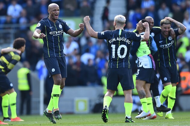 Manchester City's Argentinian striker Sergio Aguero (2L) and Manchester City's Belgian defender Vincent Kompany (L) celebrate at the final whistle of the English Premier League football match between Brighton and Hove Albion and Manchester City at the American Express Community Stadium in Brighton, southern England on May 12, 2019. - Manchester City held off a titanic challenge from Liverpool to become the first side in a decade to retain the Premier League on Sunday by coming from behind to beat Brighton 4-1 on Sunday. (Photo by Glyn KIRK / AFP) / RESTRICTED TO EDITORIAL USE. No use with unauthorized audio, video, data, fixture lists, club/league logos or 'live' services. Online in-match use limited to 120 images. An additional 40 images may be used in extra time. No video emulation. Social media in-match use limited to 120 images. An additional 40 images may be used in extra time. No use in betting publications, games or single club/league/player publications. /         (Photo credit should read GLYN KIRK/A