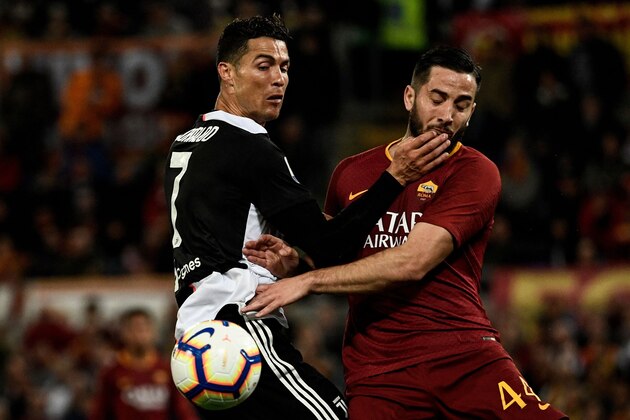 AS Roma Greek defender Konstantinos Manolas fights for the ball with Juventus' Portuguese forward Cristiano Ronaldo (L) during the Italian Serie A football match between AS Roma and Juventus Turin at the Olympic stadium in Rome, on May 12, 2019. (Photo by Filippo MONTEFORTE / AFP)        (Photo credit should read FILIPPO MONTEFORTE/AFP/Getty Images)