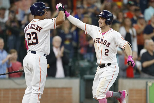 HOUSTON, TEXAS - MAY 12: Alex Bregman #2 of the Houston Astros receives congratulations from Michael Brantley #23 after hitting a two-run home run in the second inning against the Texas Rangers at Minute Maid Park on May 12, 2019 in Houston, Texas. (Photo by Bob Levey/Getty Images)