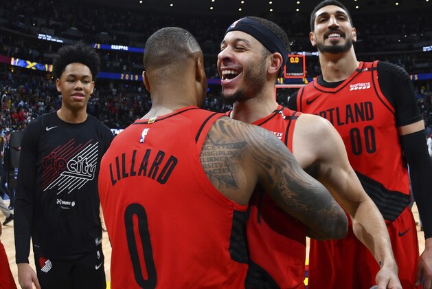 From front, Portland Trail Blazers guard Damian Lillard celebrates with guard Seth Curry and center Enes Kanter after the second half of Game 7 of an NBA basketball second-round playoff series Sunday, May 12, 2019, in Denver. The Trail Blazers won 100-96. (AP Photo/David Zalubowski)
