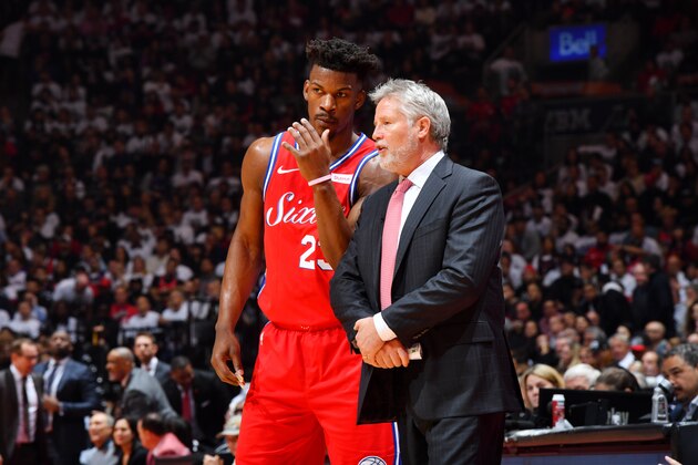 TORONTO, CANADA - MAY 12: Jimmy Butler #23 and Head Coach Brett Brown of the Philadelphia 76ers huddle together against the Toronto Raptors during Game Seven of the Eastern Conference Semi-Finals of the 2019 NBA Playoffs on May 12, 2019 at the Scotiabank Arena in Toronto, Ontario, Canada.  NOTE TO USER: User expressly acknowledges and agrees that, by downloading and or using this Photograph, user is consenting to the terms and conditions of the Getty Images License Agreement.  Mandatory Copyright Notice: Copyright 2019 NBAE (Photo by Jesse D. Garrabrant/NBAE via Getty Images)