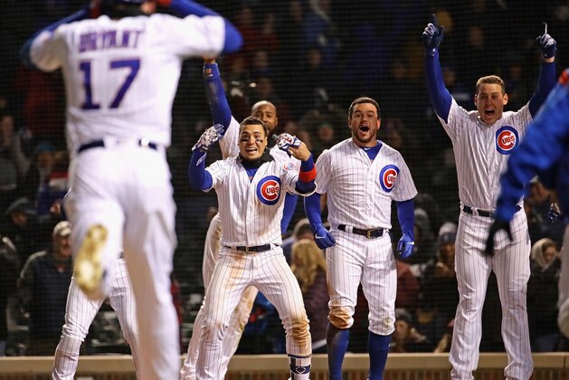 CHICAGO, ILLINOIS - MAY 07: (L-R) Javier Baez #9, Jason Heyward #22,  Kyle Schwarber #12 and Anthony Rizzo #44 of the Chicago Cubs wait for Kris Bryant #17 to cross the plate after he hit the game-winning three run home run in the bottom of the 9th inning against the Miami Marlins at Wrigley Field on May 07, 2019 in Chicago, Illinois. The Cubs defeated the Marlins 5-2. (Photo by Jonathan Daniel/Getty Images)