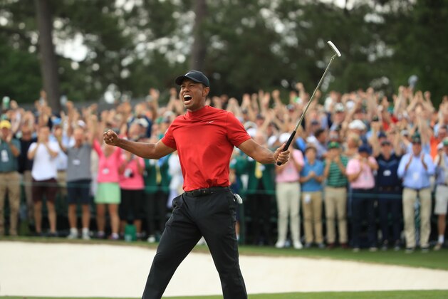 AUGUSTA, GEORGIA - APRIL 14: Tiger Woods (L) of the United States celebrates on the 18th green after winning the Masters at Augusta National Golf Club on April 14, 2019 in Augusta, Georgia. (Photo by Andrew Redington/Getty Images)