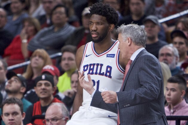 Philadelphia 76ers head coach Brett Brown, right, talks to center Joel Embiid during the first half of an NBA basketball game in Portland, Ore., Thursday, Dec. 28, 2017. (AP Photo/Craig Mitchelldyer)