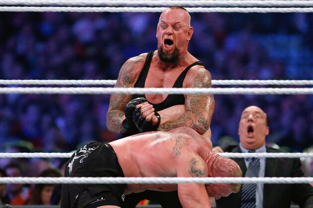IMAGE DISTRIBUTED FOR WWE - The Undertaker, top, and Brock Lesnar wrestle during Wrestlemania XXX at the Mercedes-Benz Super Dome in New Orleans on Sunday, April 6, 2014. (Jonathan Bachman/AP Images for WWE)