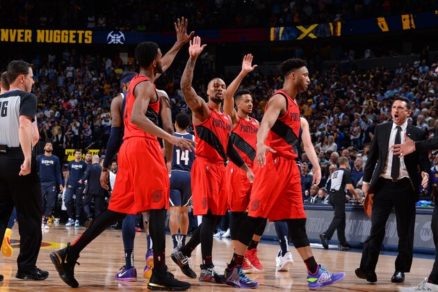 DENVER, CO - MAY 12: Damian Lillard #0 of the Portland Trail Blazers high-fives teammates against the Denver Nuggets during Game Seven of the Western Conference Semifinals of the 2019 NBA Playoffs on May 12, 2019 at the Pepsi Center in Denver, Colorado. NOTE TO USER: User expressly acknowledges and agrees that, by downloading and/or using this Photograph, user is consenting to the terms and conditions of the Getty Images License Agreement. Mandatory Copyright Notice: Copyright 2019 NBAE (Photo by Bart Young/NBAE via Getty Images)