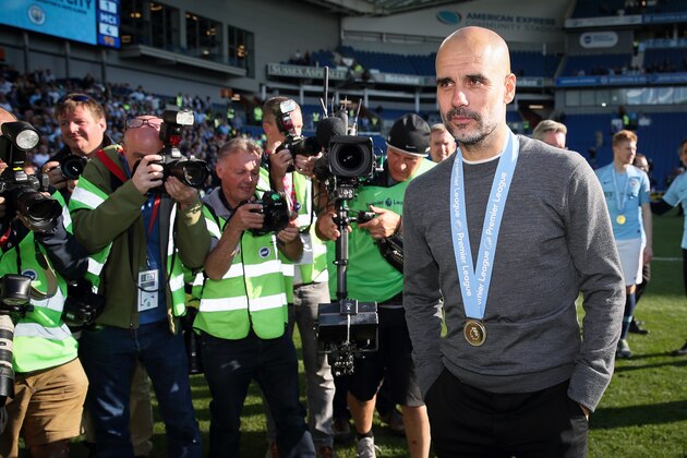 BRIGHTON, ENGLAND - MAY 12: Pep Guardiola the head coach / manager of Manchester City wearing a winners medal after becoming 2019 Champions after the Premier League match between Brighton & Hove Albion and Manchester City at American Express Community Stadium on May 12, 2019 in Brighton, United Kingdom. (Photo by Matthew Ashton - AMA/Getty Images)