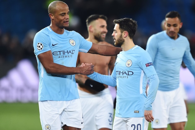 Manchester City's Belgian defender Vincent Kompany (L) celebrates with Manchester City's Portuguese midfielder Bernardo Silva (R) after winning the UEFA Champions League round of 16 first leg football match between Basel and Manchester City at the Saint Jakob-Park Stadium in Basel on February 13, 2018. / AFP PHOTO / SEBASTIEN BOZON        (Photo credit should read SEBASTIEN BOZON/AFP/Getty Images)