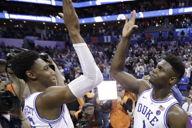 Duke's RJ Barrett (5) and Zion Williamson (1) celebrate after defeating Florida State in the NCAA college basketball championship game of the Atlantic Coast Conference tournament in Charlotte, N.C., Saturday, March 16, 2019. (AP Photo/Chuck Burton)