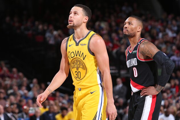 PORTLAND, OR - FEBRUARY 13: Stephen Curry #30 of the Golden State Warriors and Damian Lillard #0 of the Portland Trail Blazers look on during the game on February 13, 2019 at the Moda Center in Portland, Oregon. NOTE TO USER: User expressly acknowledges and agrees that, by downloading and/or using this photograph, user is consenting to the terms and conditions of the Getty Images License Agreement. Mandatory Copyright Notice: Copyright 2019 NBAE (Photo by Sam Forencich/NBAE via Getty Images)