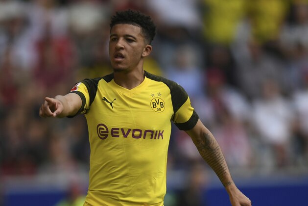 Dortmund's scorer Jadon Sancho celebrates his opening goal during the German Bundesliga soccer match between SC Freiburg and Borussia Dortmund in Freiburg, Germany, Sunday, April 21, 2019.  (Patrick Seeger/dpa via AP)