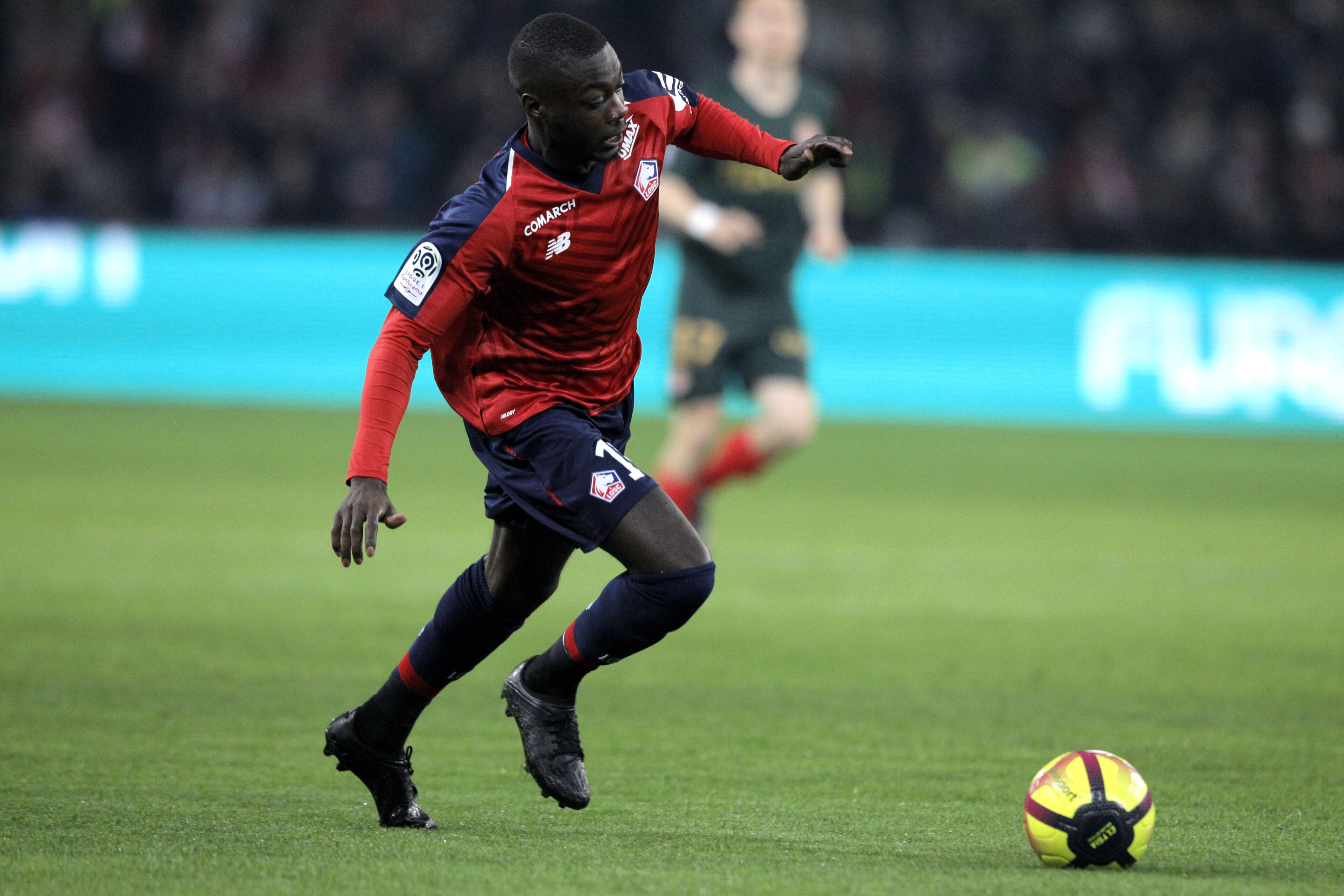 Lille's Nicolas Pepe controls the ball during the French League One soccer match between Lille and Monaco at the Lille Metropole stadium, in Villeneuve d'Ascq, northern France, Friday, March 15, 2019. (AP Photo/Michel Spingler)