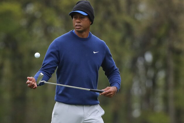 Tiger Woods flips his ball as he walks along the ninth green during a practice round for the PGA Championship golf tournament, Monday, May 13, 2019, in Farmingdale, N.Y. (AP Photo/Julie Jacobson)