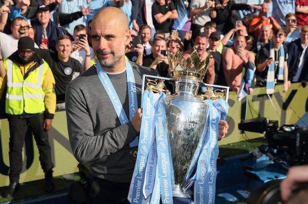 BRIGHTON, ENGLAND - MAY 12: Pep Guardiola the head coach / manager of Manchester City shows the Premier League Trophy to fans of Manchester City during the celebrations of becoming 2019 Champions after the Premier League match between Brighton & Hove Albion and Manchester City at American Express Community Stadium on May 12, 2019 in Brighton, United Kingdom. (Photo by Matthew Ashton - AMA/Getty Images)