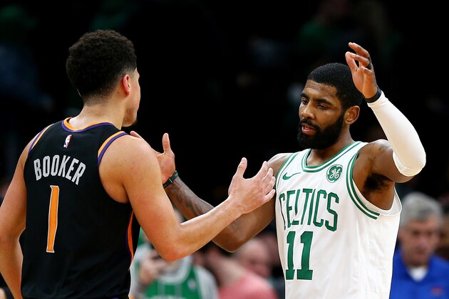 BOSTON, MASSACHUSETTS - DECEMBER 19: Kyrie Irving #11 of the Boston Celtics congratulates Devin Booker #1 of the Phoenix Suns after the game at TD Garden on December 19, 2018 in Boston, Massachusetts. The Suns defeat the Celtics 11-103. NOTE TO USER: User expressly acknowledges and agrees that, by downloading and or using this photograph, User is consenting to the terms and conditions of the Getty Images License Agreement. (Photo by Maddie Meyer/Getty Images)