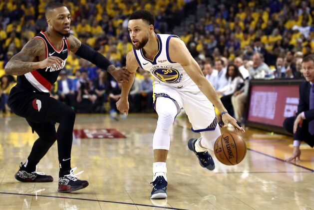 OAKLAND, CALIFORNIA - MAY 14: Stephen Curry #30 of the Golden State Warriors dribbles against Damian Lillard #0 of the Portland Trail Blazers during the first half in game one of the NBA Western Conference Finals at ORACLE Arena on May 14, 2019 in Oakland, California. NOTE TO USER: User expressly acknowledges and agrees that, by downloading and or using this photograph, User is consenting to the terms and conditions of the Getty Images License Agreement. (Photo by Ezra Shaw/Getty Images)