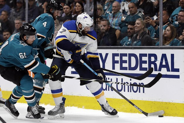 St. Louis Blues' Pat Maroon, right, moves the puck past San Jose Sharks' Justin Braun, left, and Brenden Dillon (4) during the second period in Game 2 of the NHL hockey Stanley Cup Western Conference finals, Monday, May 13, 2019, in San Jose, Calif. (AP Photo/Ben Margot)