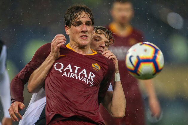 ROME, ITALY - APRIL 13: Nicolò Zaniolo of AS Roma is challenged by Jens Stryger Larsen of Udinese during the Serie A match between AS Roma and Udinese at Stadio Olimpico on April 13, 2019 in Rome, Italy. (Photo by Giampiero Sposito/Getty Images)