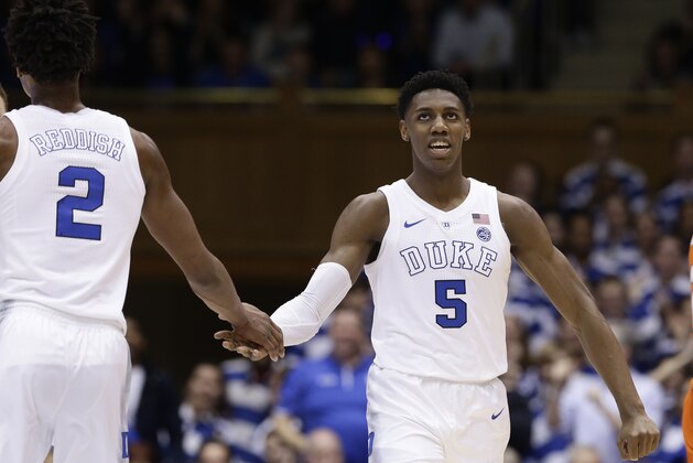 Duke's RJ Barrett (5) and Cam Reddish (2) react during the first half of an NCAA college basketball game against against Miami in Durham, N.C., Saturday, March 2, 2019. (AP Photo/Gerry Broome)