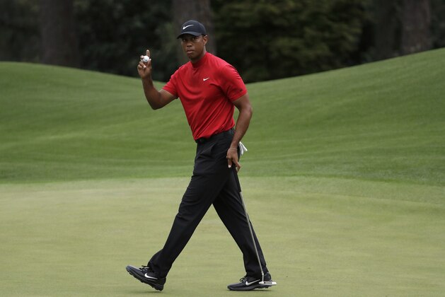 FILE - In this April 14, 2019, file photo, Tiger Woods waves on the eighth hole during the final round of the Masters golf tournament in Augusta, Ga.Harold Varner III worked up the courage to ask a favor of Tiger Woods for a close friend, Daniel Meggs, battling colon cancer. Woods made a videotape message for Meggs on the Wednesday of the Masters, offering encouragement to the former Wake Forest golfer to keep fighting and to never give up hope. (AP Photo/Chris Carlson, File)