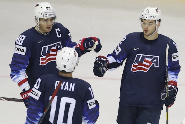 Alex Debrincat of the US, right, celebrates with teammates Patrick Kane, left, and Derek Ryan, center, after scoring his sides fourth goal during the Ice Hockey World Championships group A match between the United States and Great Britain at the Steel Arena in Kosice, Slovakia, Wednesday, May 15, 2019. (AP Photo/Petr David Josek)