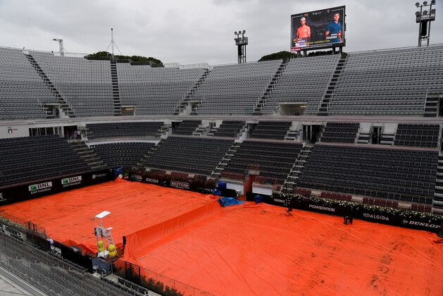 This general view shows the covers on the Central Court at Foro Italico in Rome on May 15, 2019, as rain stopped play on the fourth day of The ATP/WTA Rome Masters tennis tournament. (Photo by Tiziana FABI / AFP)        (Photo credit should read TIZIANA FABI/AFP/Getty Images)