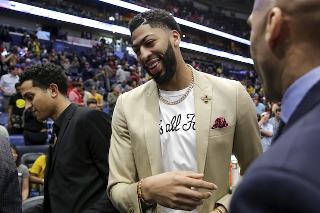 New Orleans Pelicans forward Anthony Davis, wearing a 'That's All Folks,' T-shirt under his jacket, exits the floor, possibly for the last time at a Pelican, after an NBA basketball game against the Golden State Warriors in New Orleans, Tuesday, April 9, 2019. The Warriors won 112-103. (AP Photo/Scott Threlkeld)