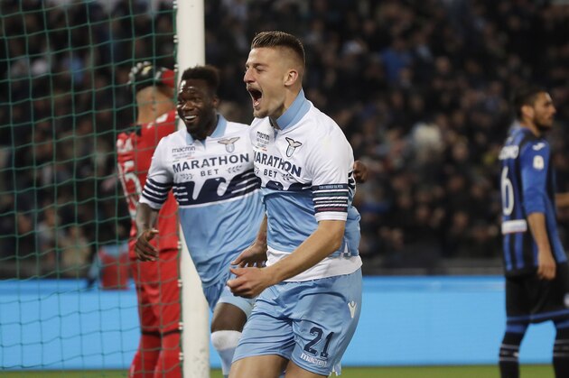 Lazio's Sergej Milinkovic Savic, right, celebrates after scoring his side's opening goal during the Italian Cup soccer final match between Lazio and Atalanta, at the Rome Olympic stadium, Wednesday, May 15, 2019. (AP Photo/Alessandra Tarantino)